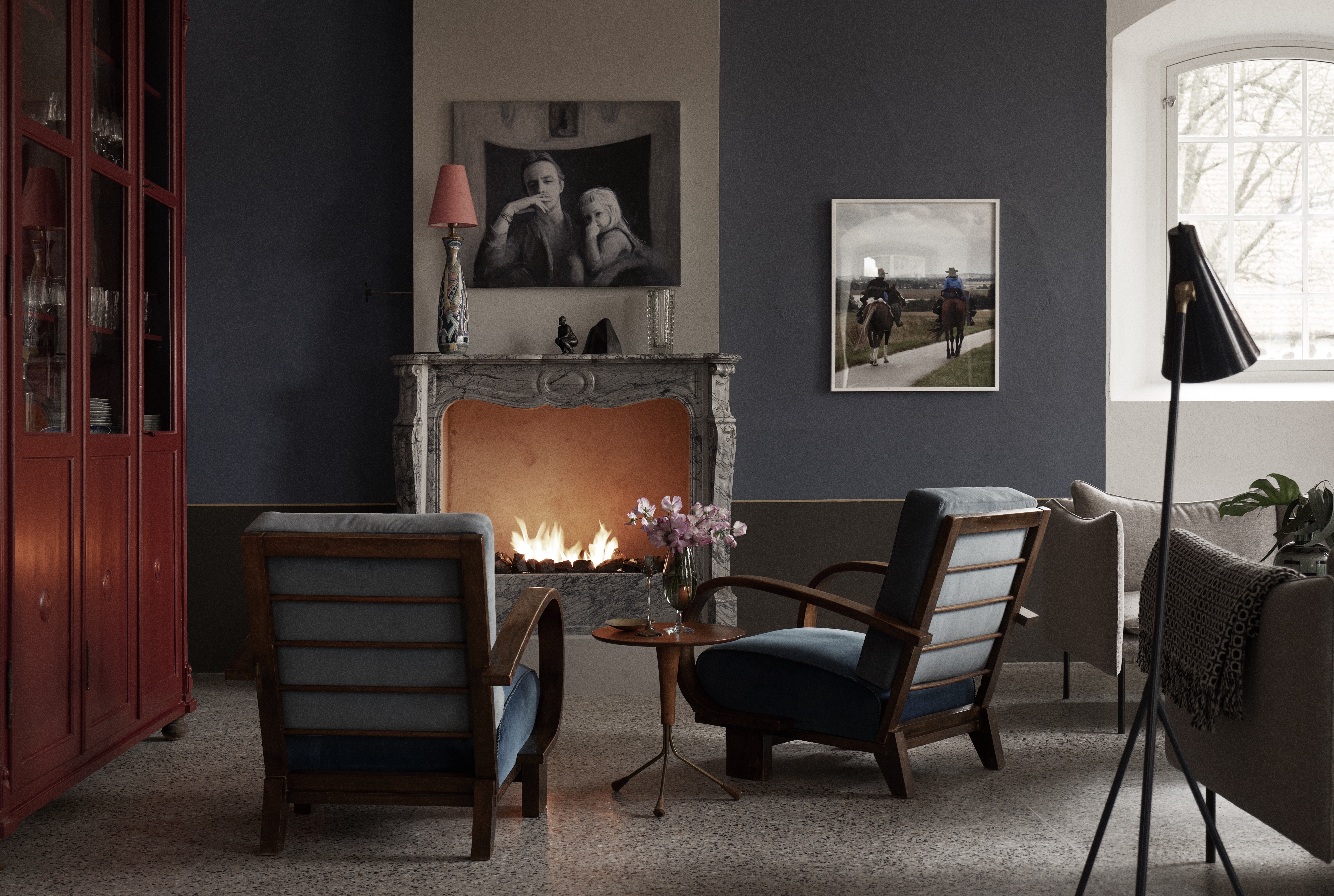 Fireplace with two armchairs positioned in front, creating a cozy lounge setting"