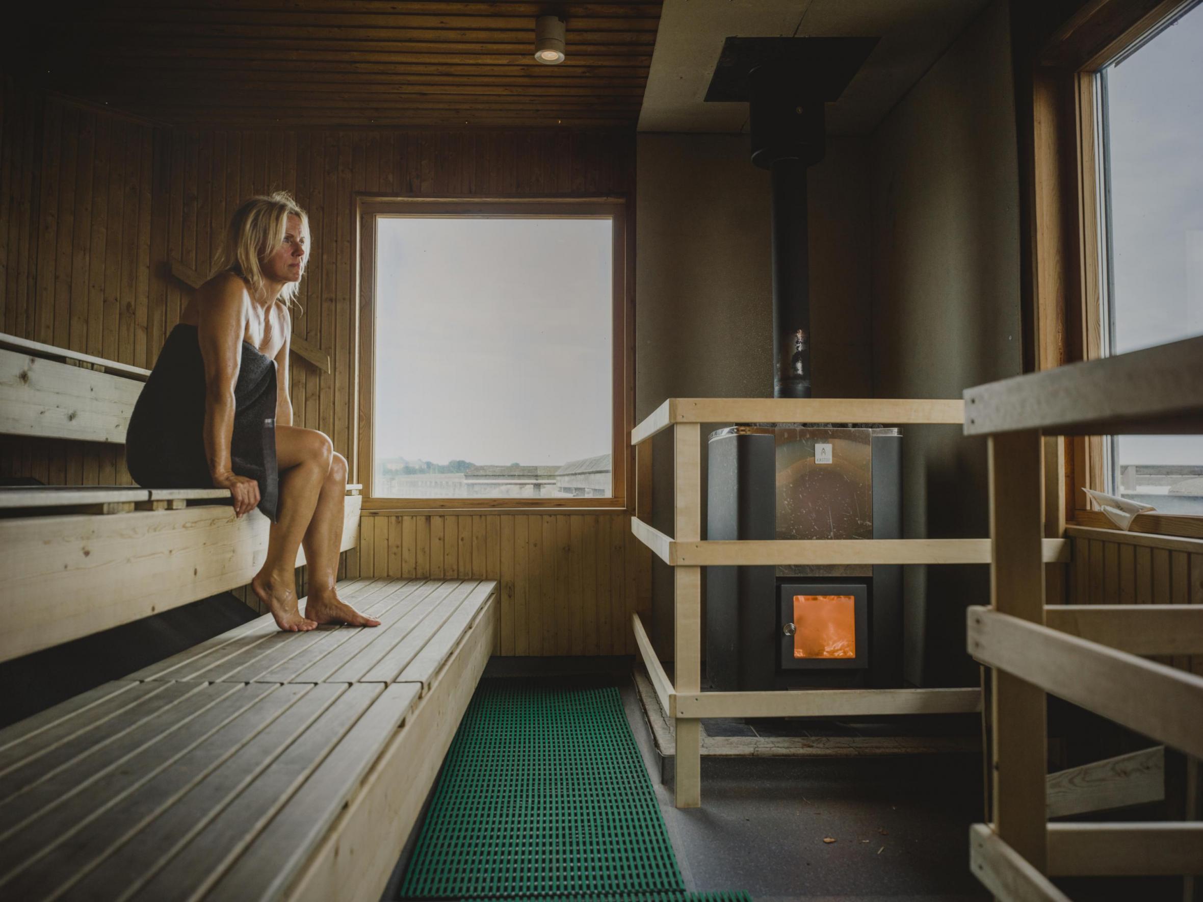 Woman in sauna looking through window