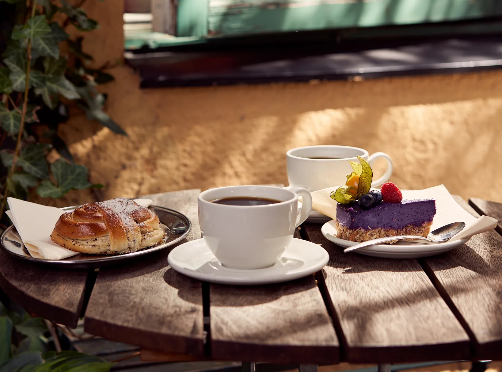 Coffee cup and cakes on outdoor café table 