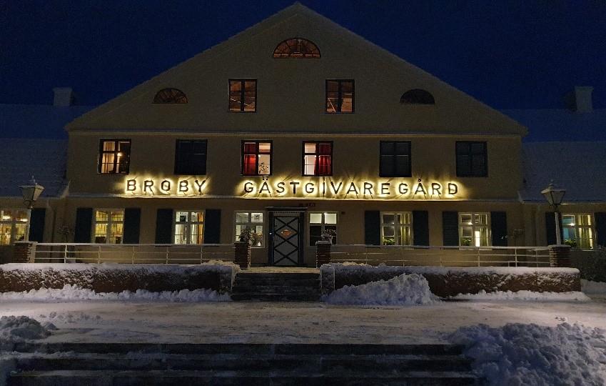 Light yellow facade of an inn in winter attire