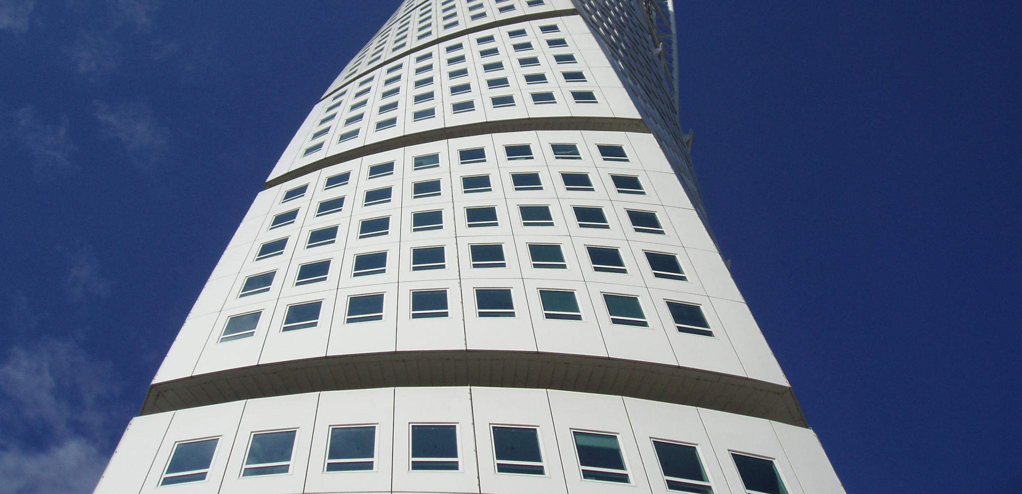 a close up view of Turning Torso towering upp in the sky