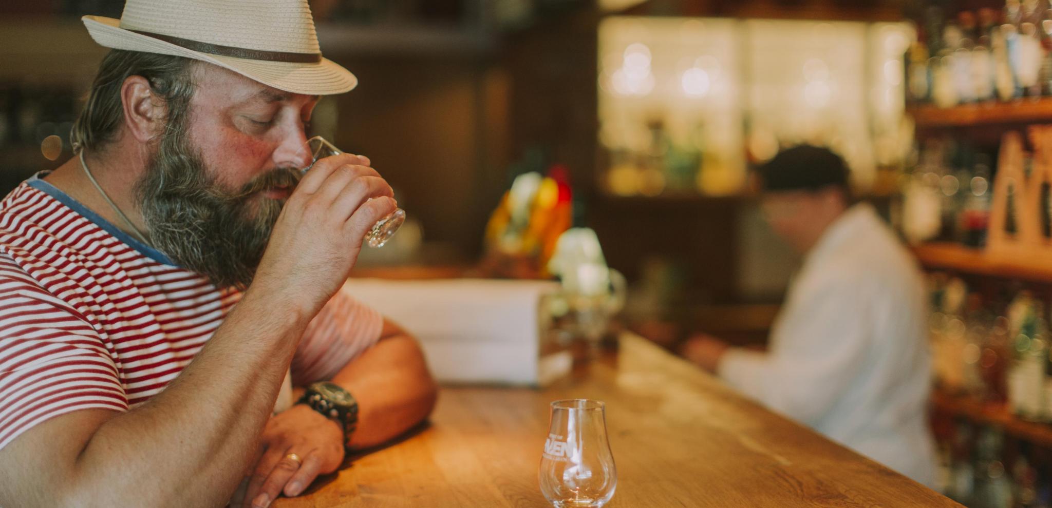Man tasting whiskey in a bar