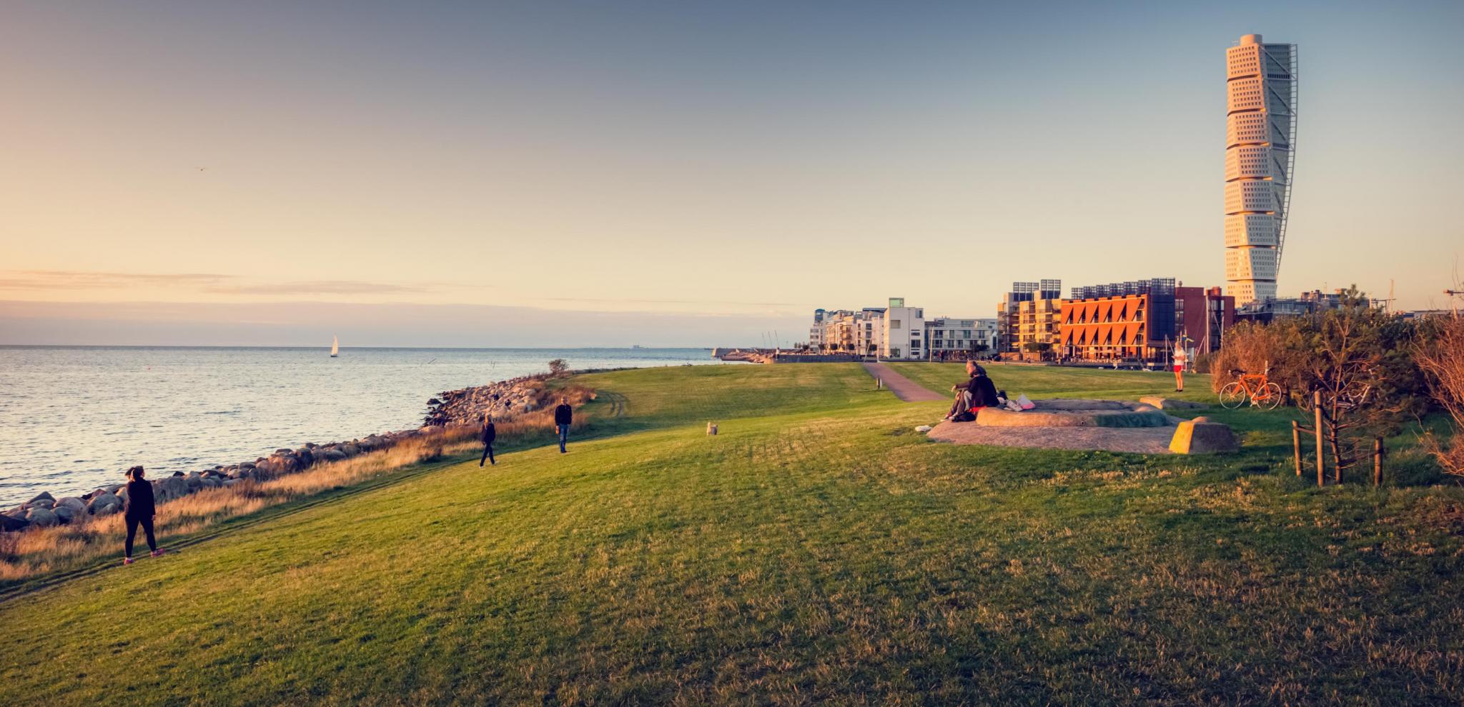 People enjoy a beautiful sunset near the turning torso 