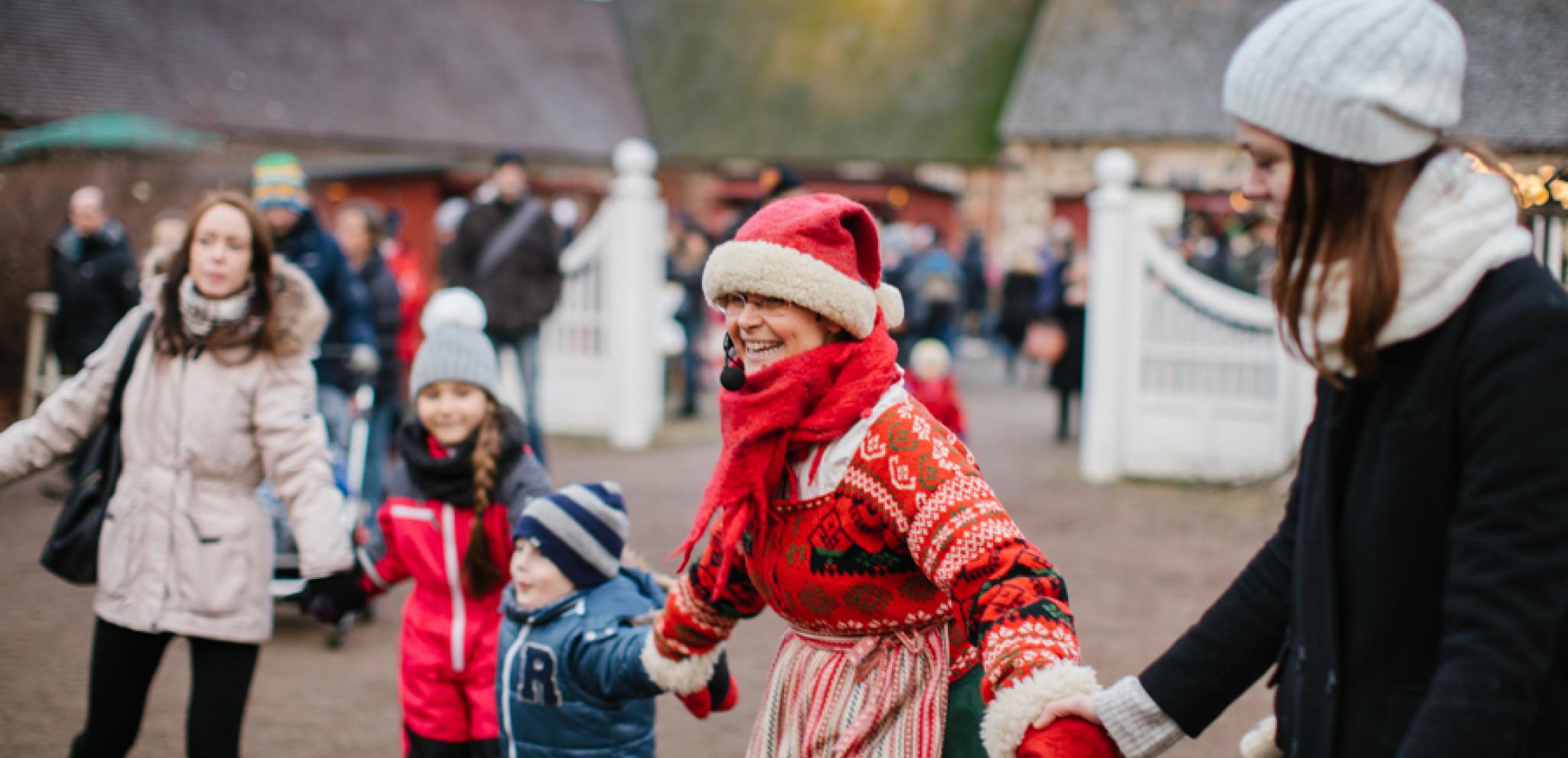 Children and adults holding hands dressed in christmas clothes