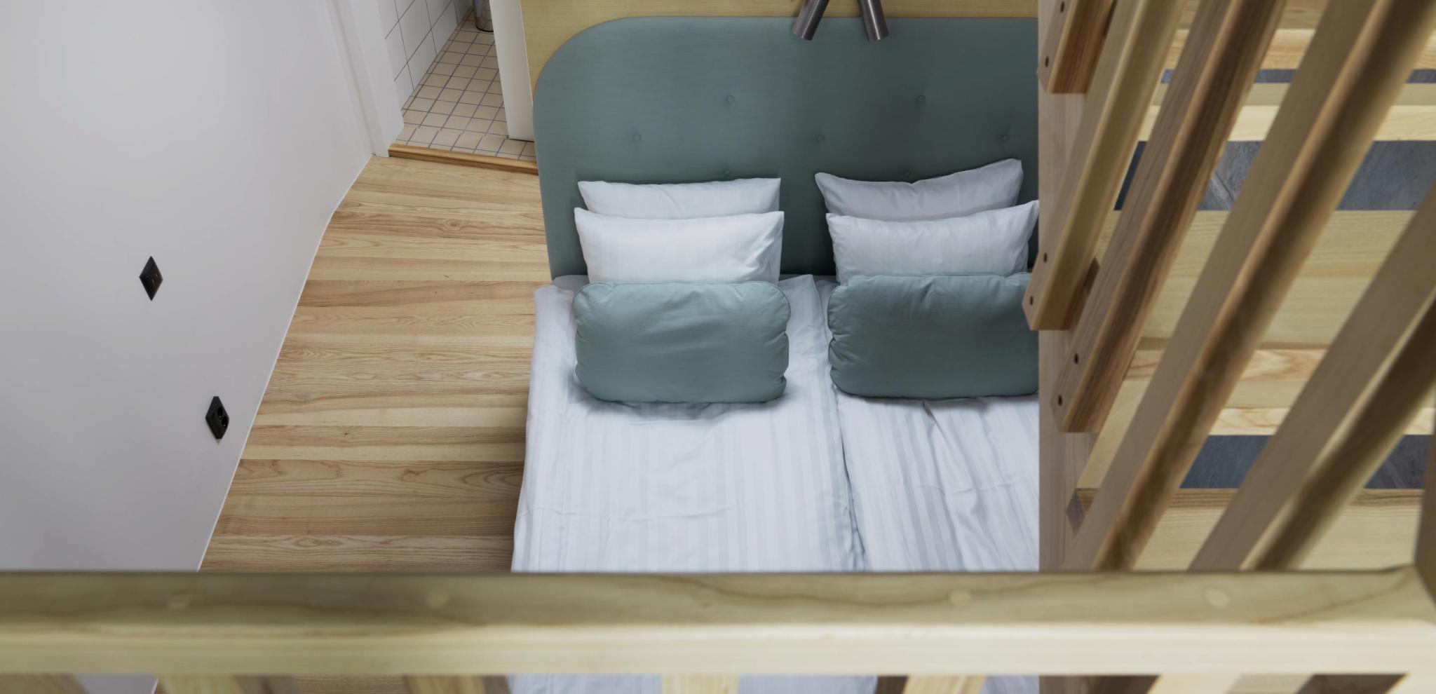 View of a bed and a wooden staircase from a second floor 