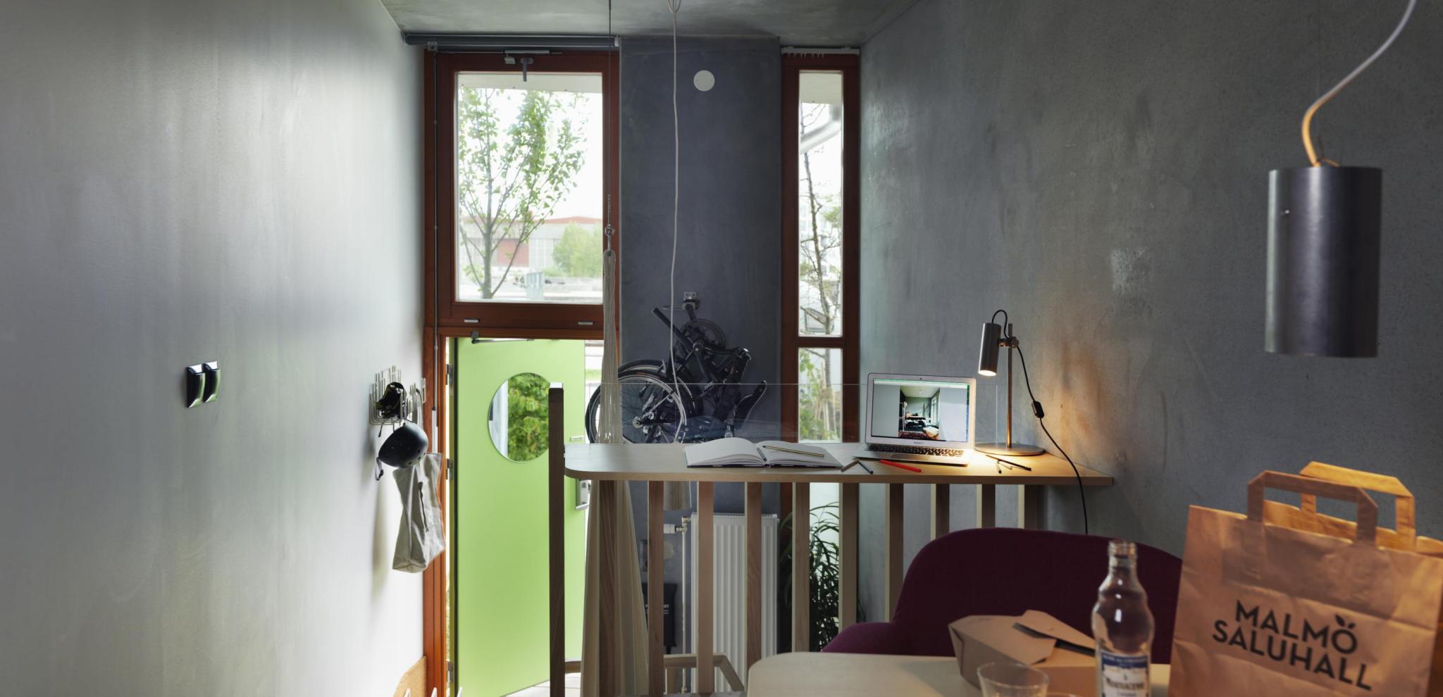 Interior of ohboy Hotel room with table and green door 