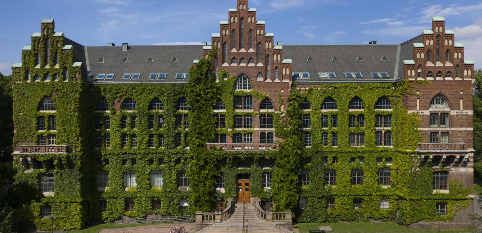 The majestic university library of Lund, covered in green plants