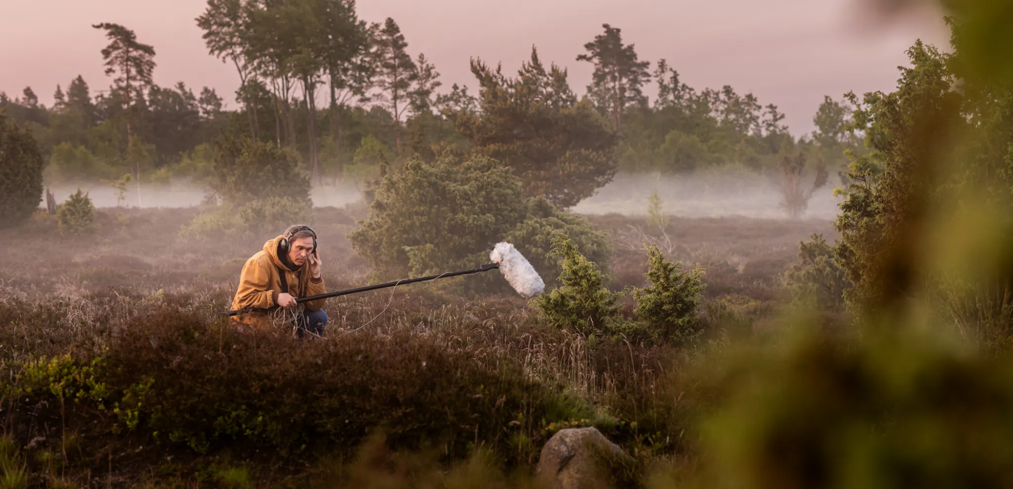 A man with a microphone in a field