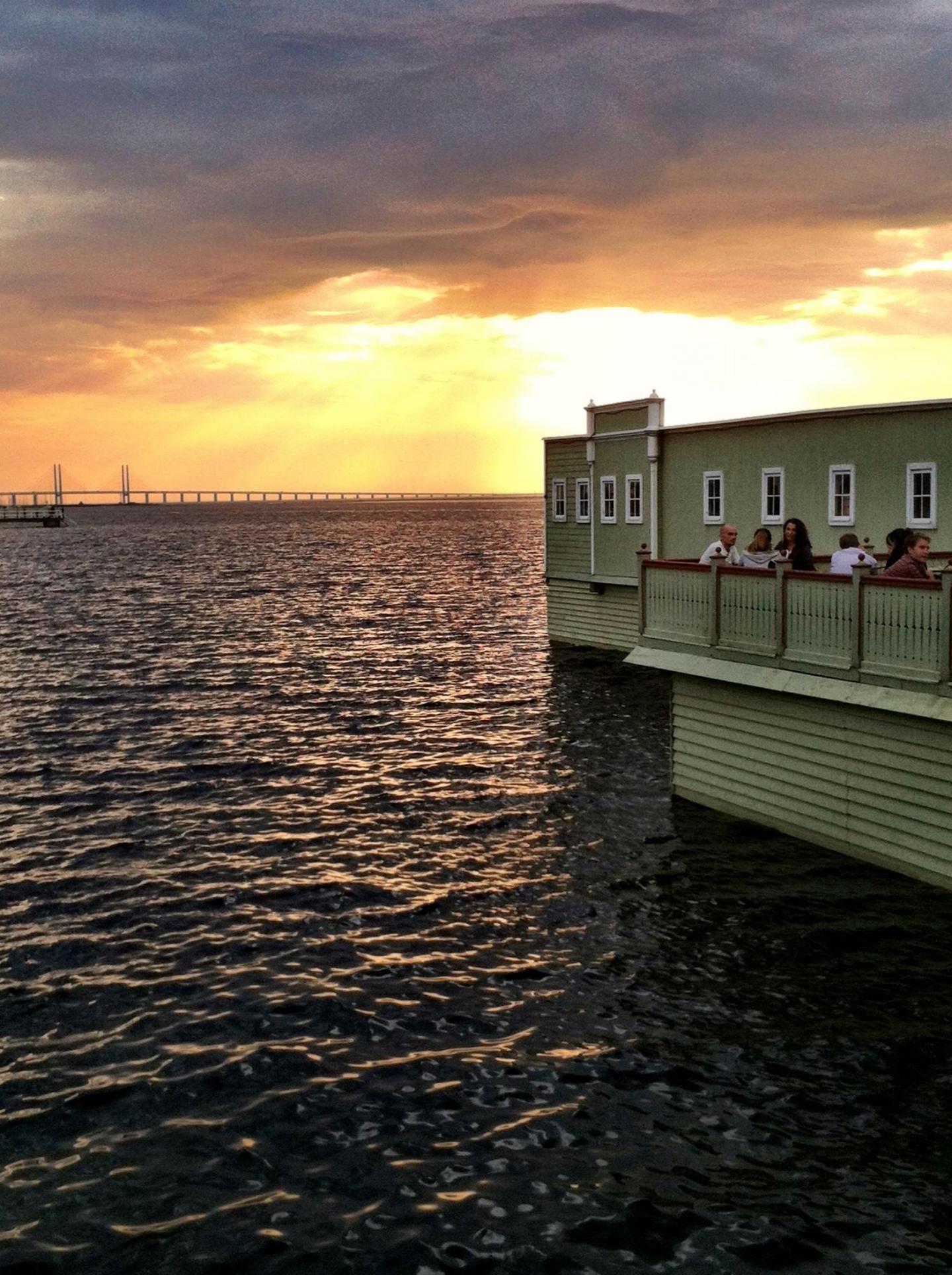 View of the sundown behind The Öresund Bridge and Ribersborg's cold bath house