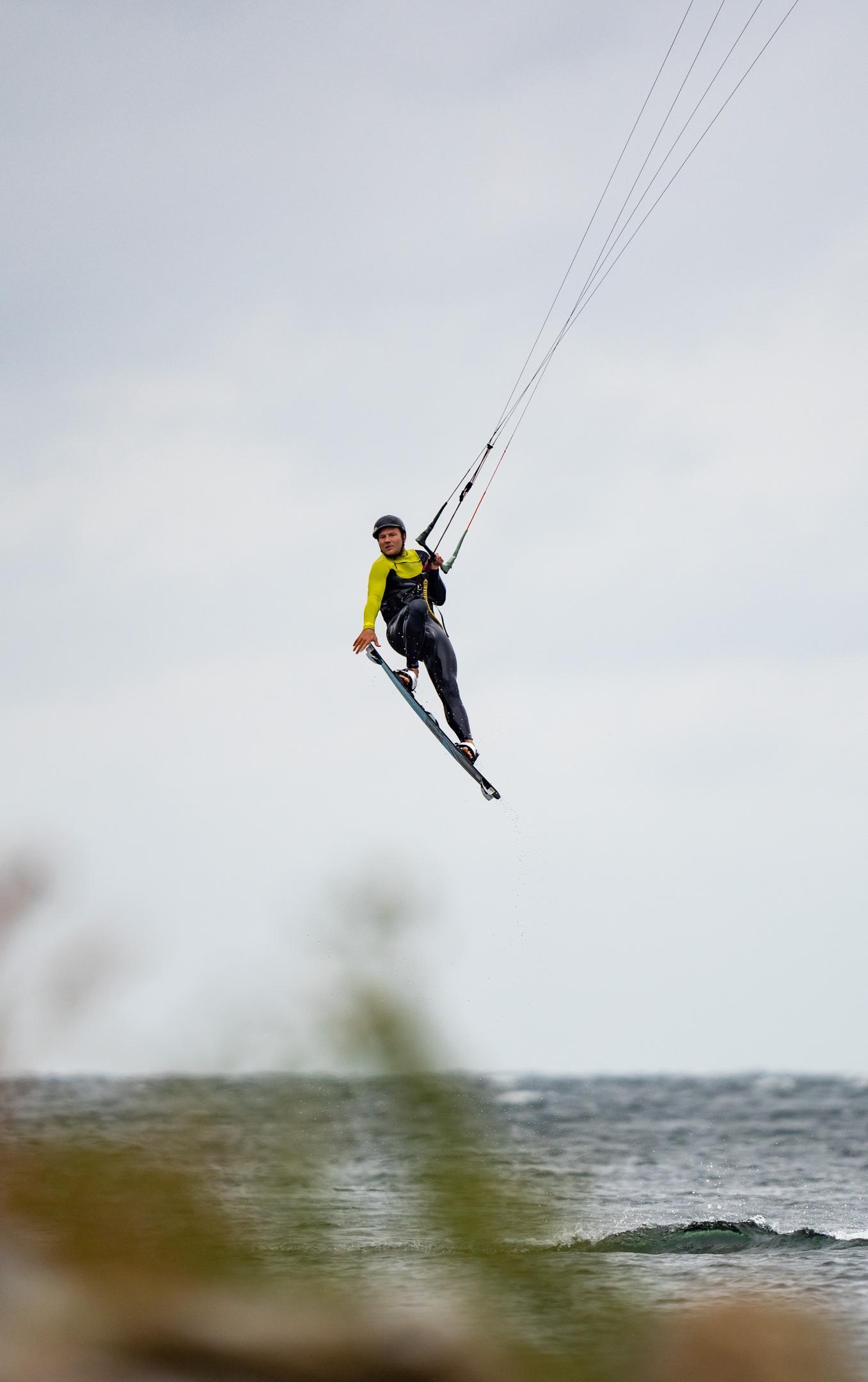 Kitesurfer in the air gray sky
