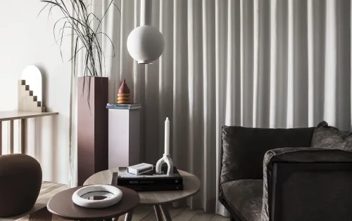 Hotel apartment environment with a sofa, coffee table, and decor