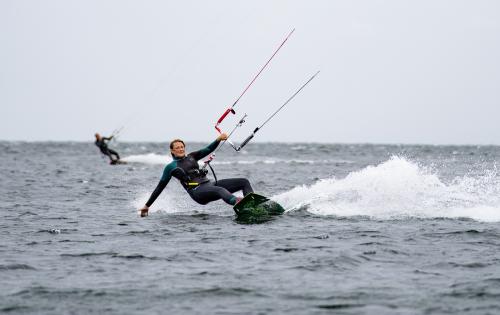 Woman kite surfing on water