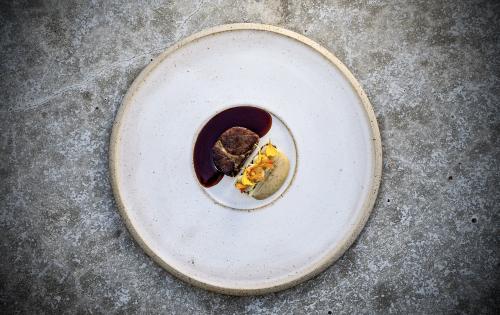 Ceramic white plate with a sophisticated meat and potato serving