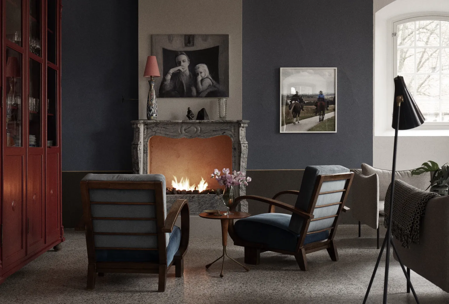 Fireplace with two armchairs positioned in front, creating a cozy lounge setting"