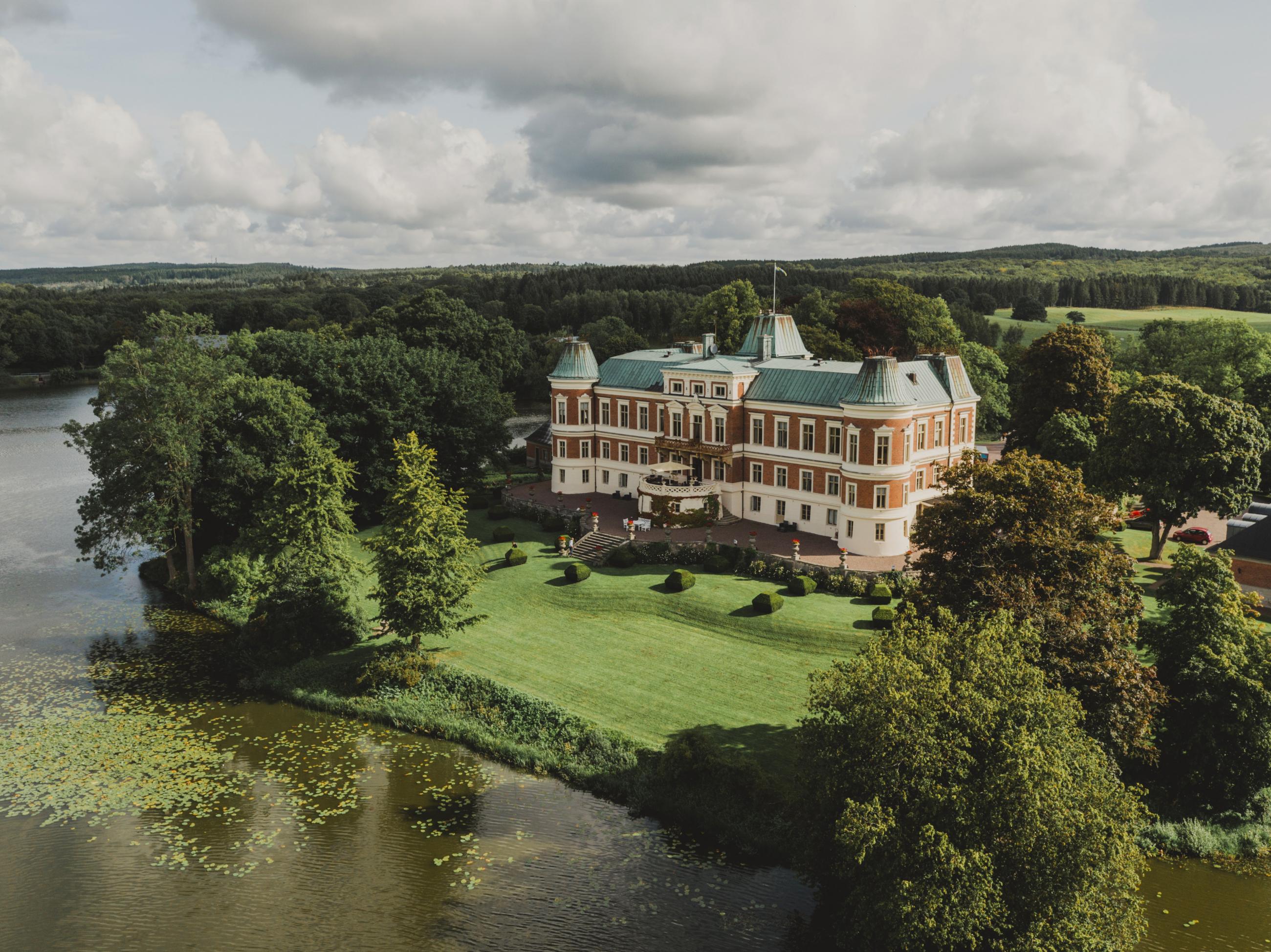 Sky view of Häckeberga castle surrounded by water and trees