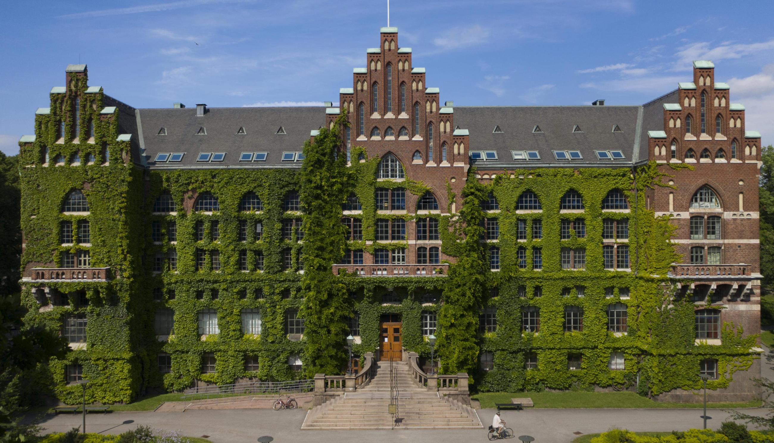 Historic library building facade covered in green ivy, creating a charming architectural scene