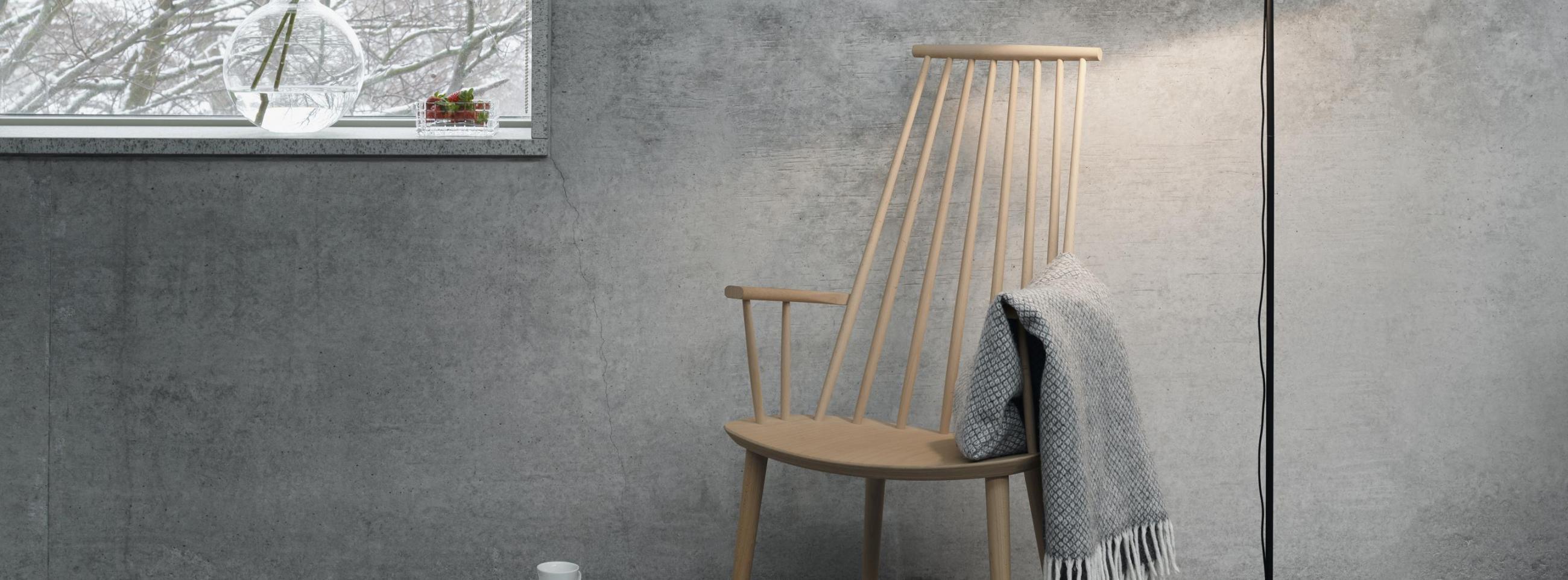 Grey room with rocking chair, blanket and a floor lamp