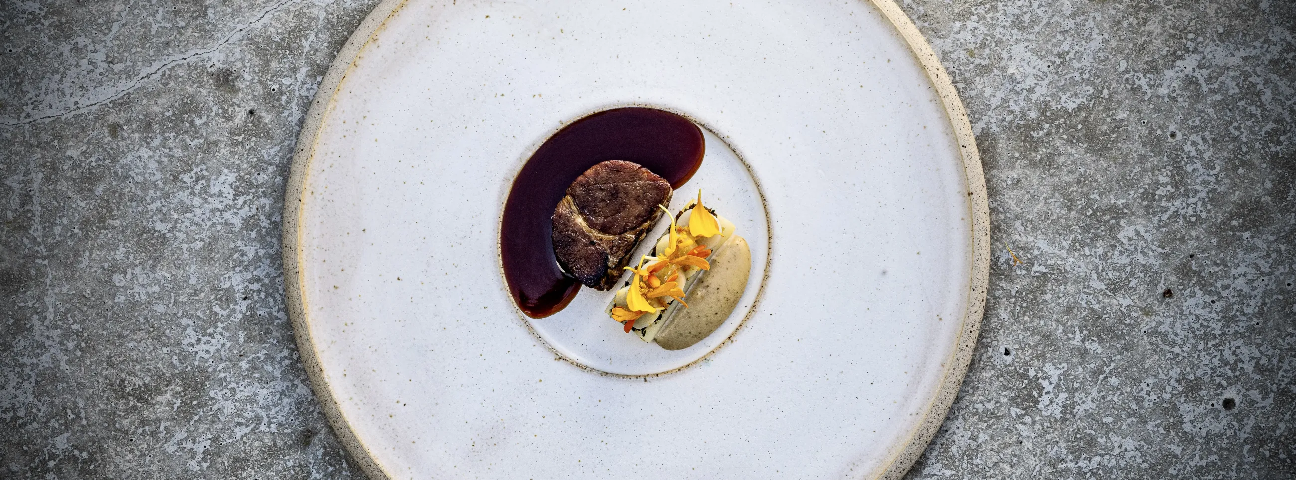 Ceramic white plate with a sophisticated meat and potato serving