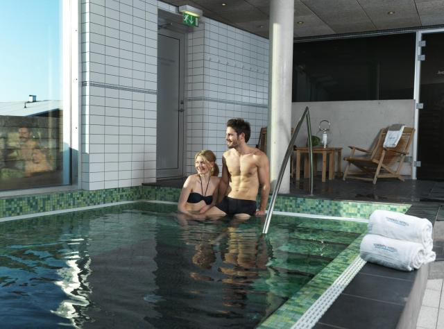 Couple bathing and enjoying the view from the spa pool at Torekov Hotell