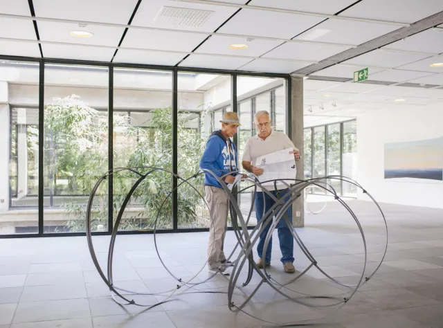Two men inspect the artwork © Anders Ebefeldt Studio E