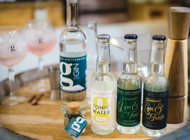 Gin and tonic bottles on a barrel