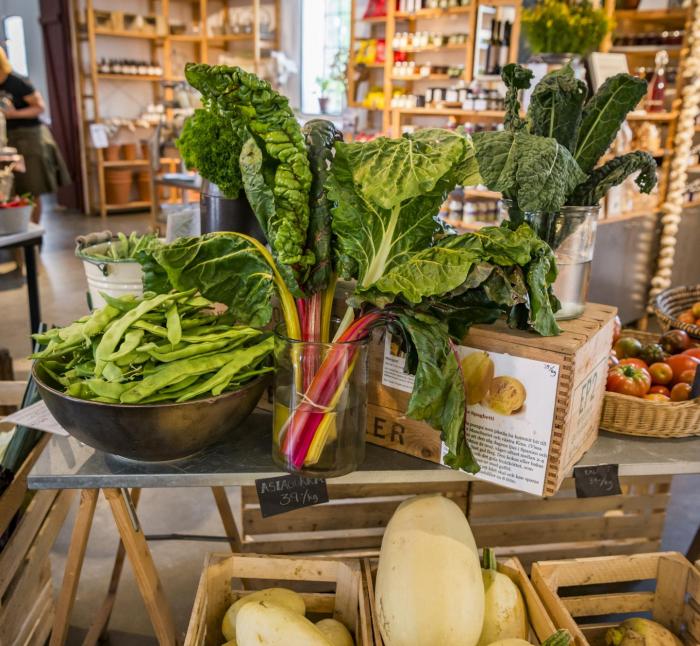 A table with vegetables in a shop.