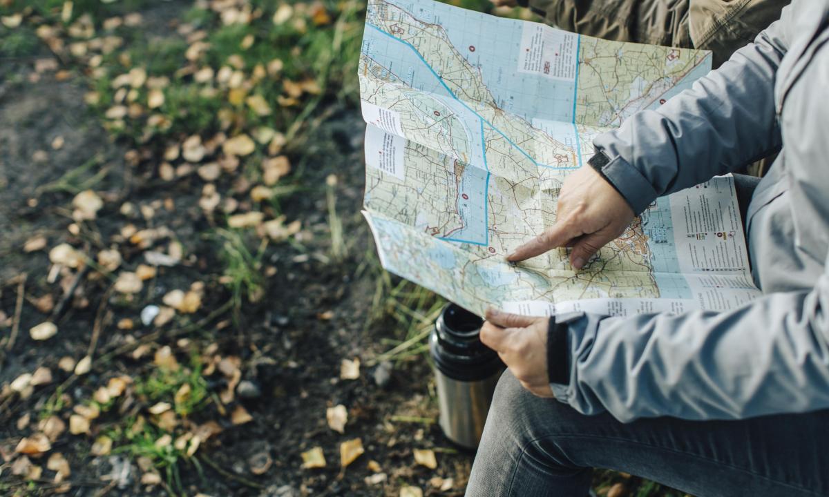 hand up close pointing at a map