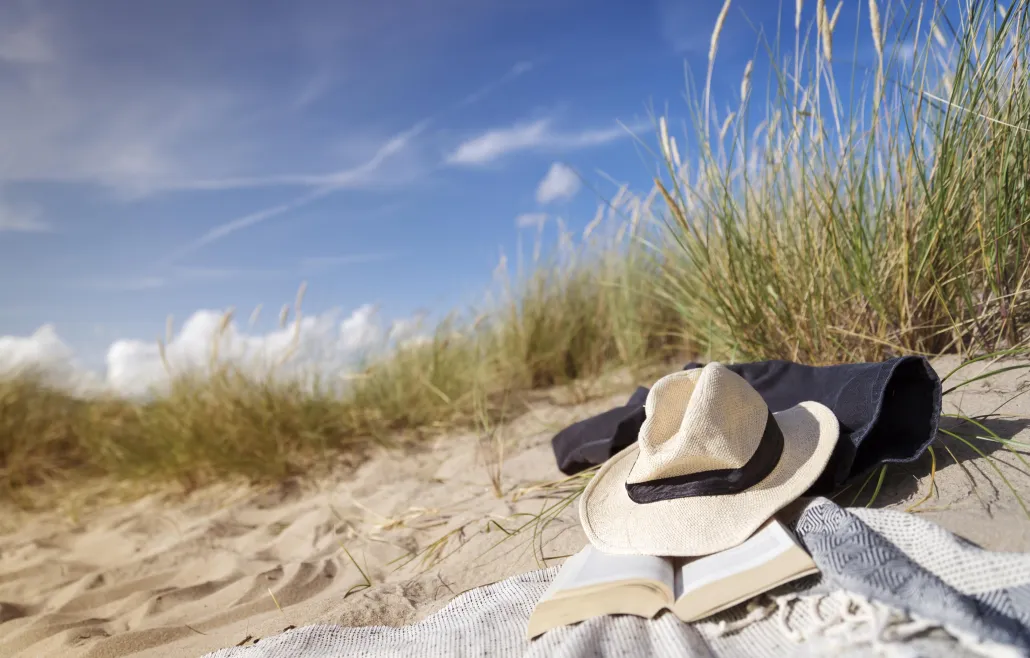 Two women walking on the sandy beach in summer